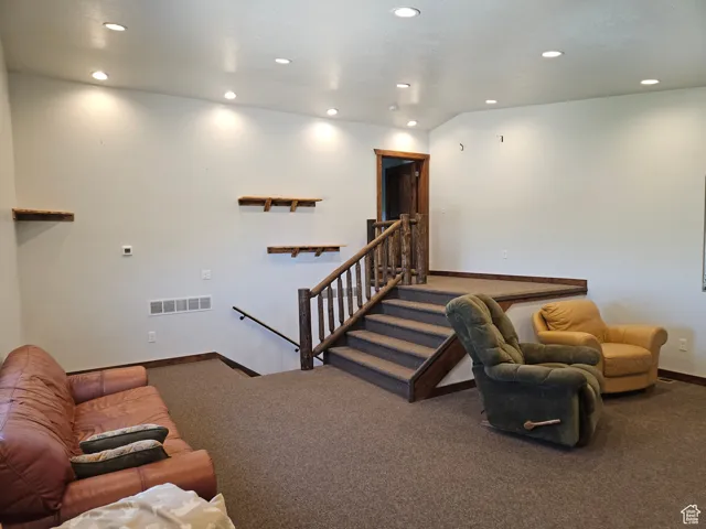 Living area with recessed lighting, carpet, and baseboards