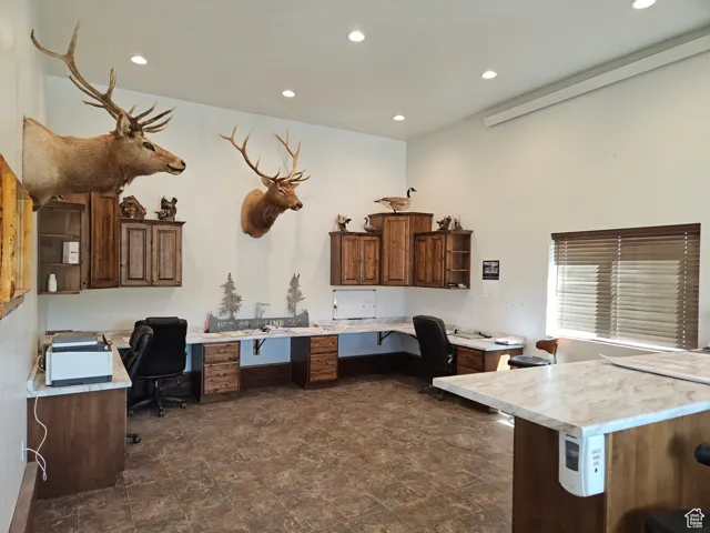 Office area featuring built in desk and recessed lighting