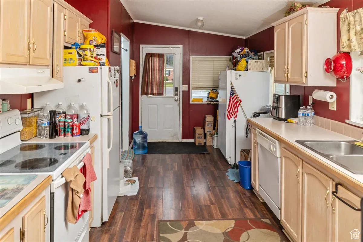 Kitchen with vaulted ceiling, dark hardwood / wood-style floors, white appliances