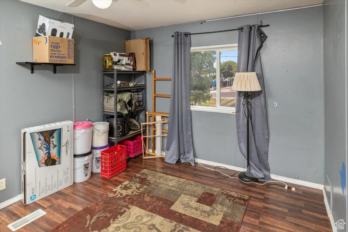Bedroom 2 with dark wood-type flooring and ceiling fan
