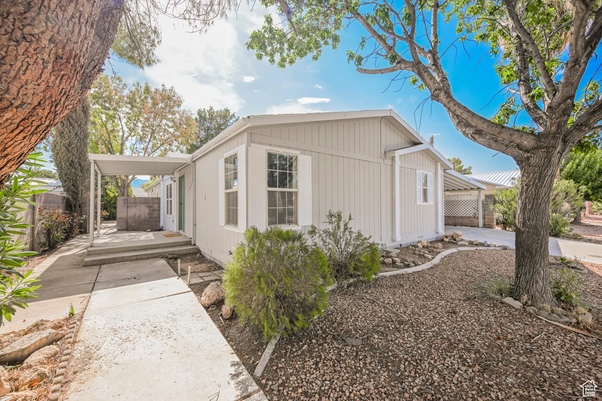 View of property exterior featuring a carport