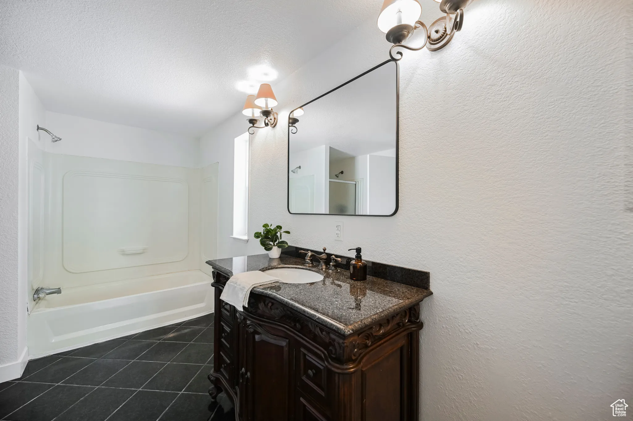Bathroom with shower / bath combination, vanity, and tile patterned flooring