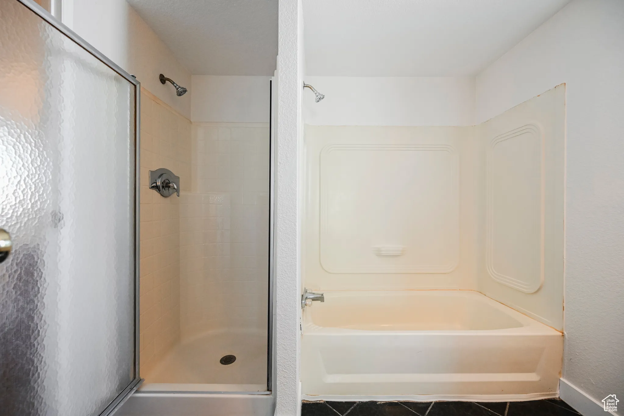 Bathroom featuring tiled shower and tile patterned flooring
