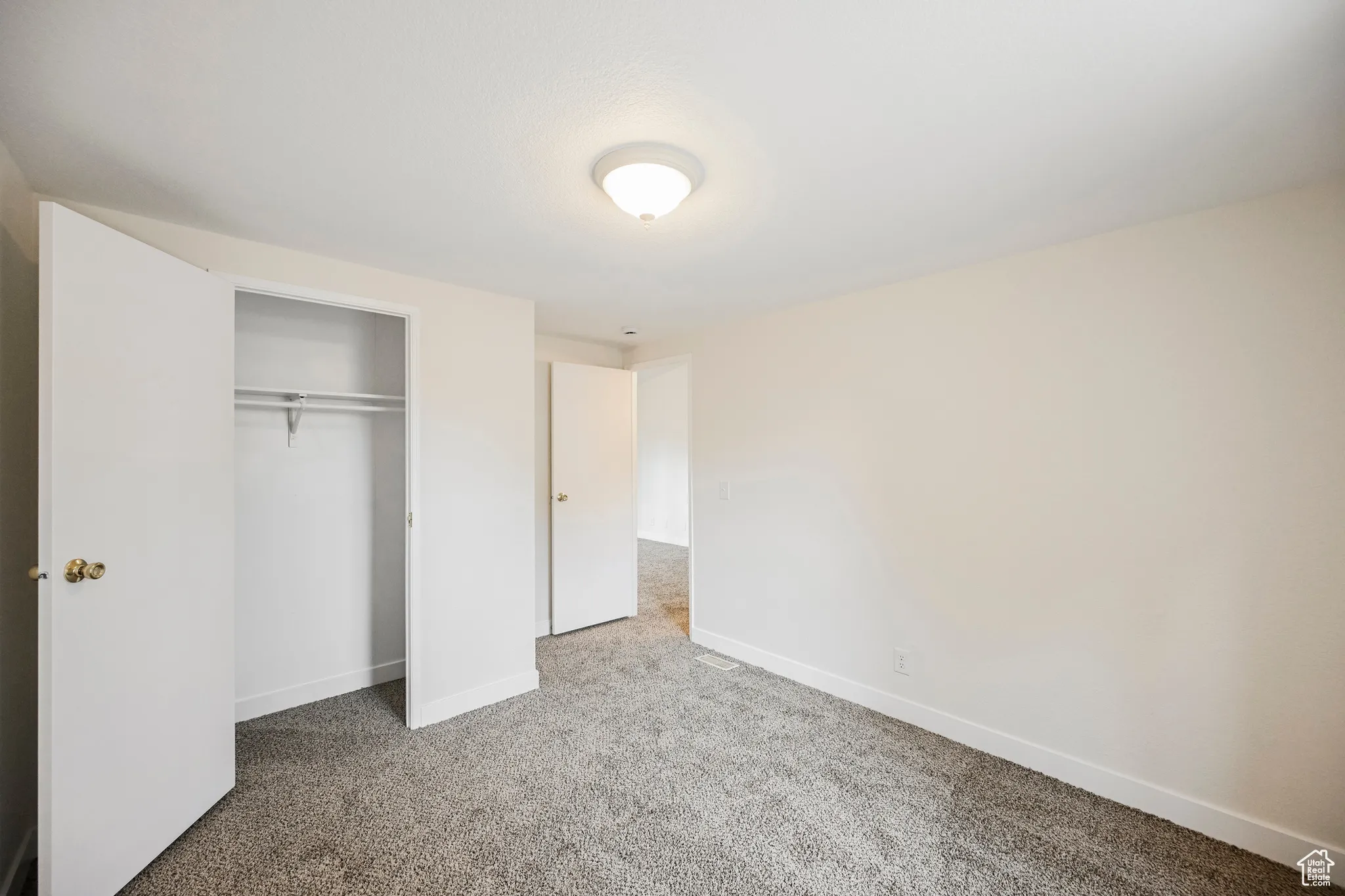 Unfurnished bedroom featuring a closet and carpet