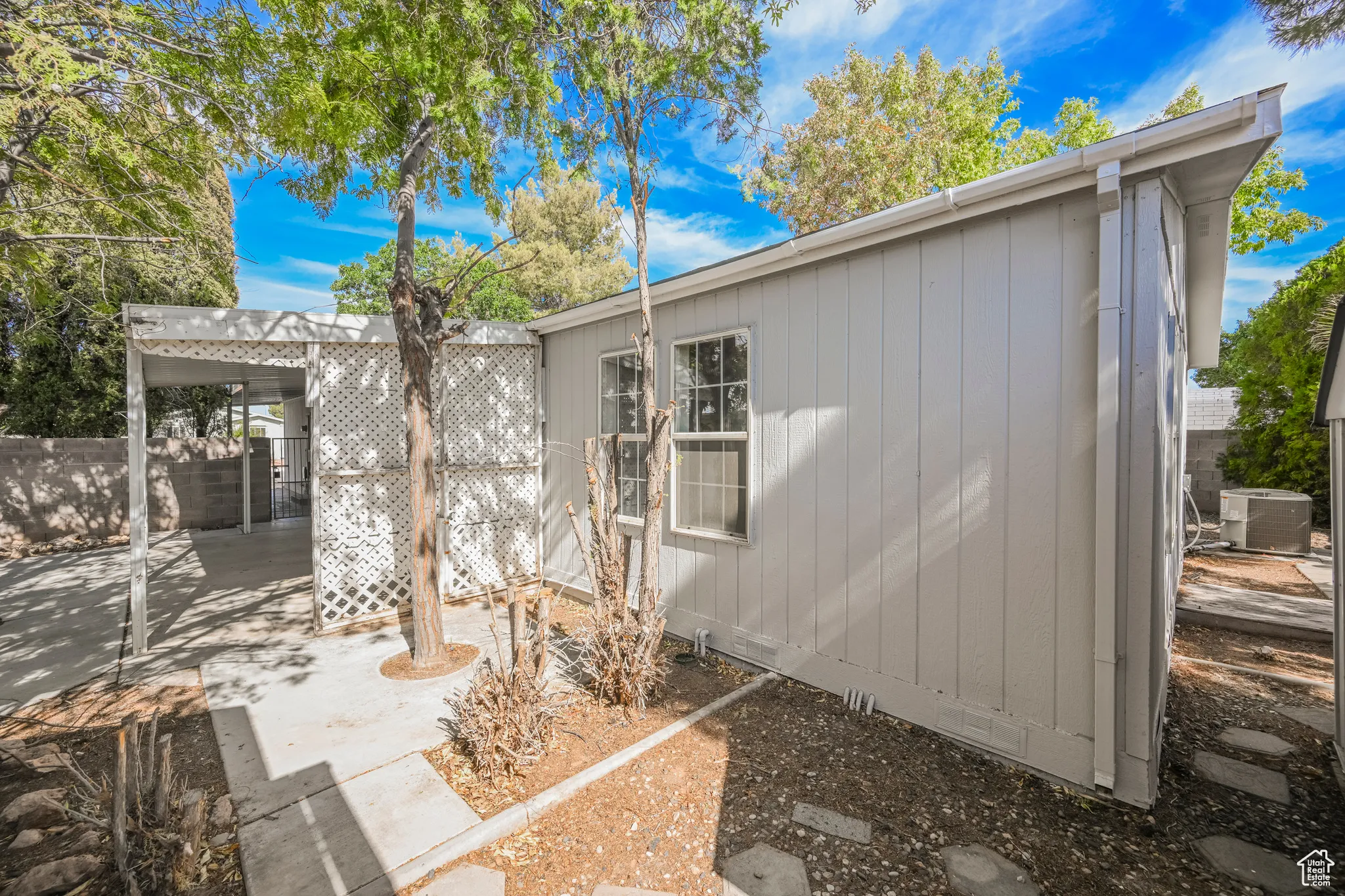 Back of house featuring central air condition unit and a patio area