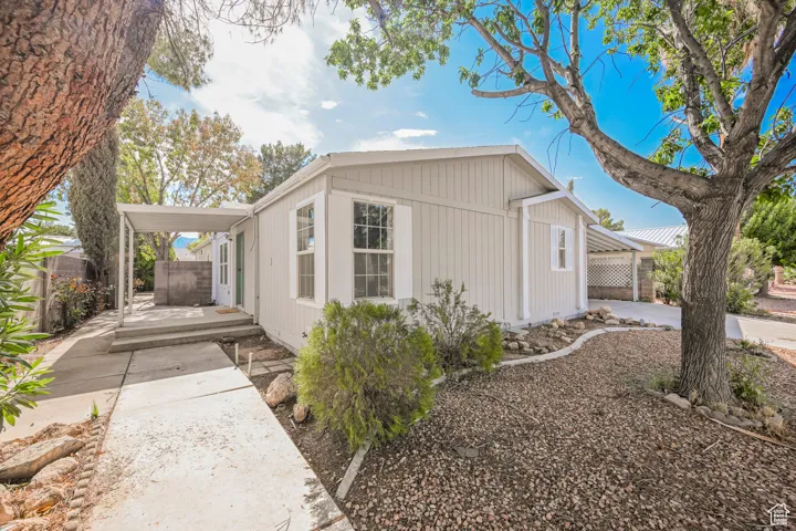 View of property exterior featuring a carport