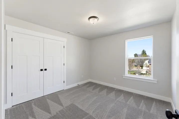 Unfurnished bedroom with carpet and a closet