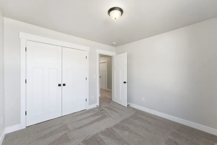 Unfurnished bedroom with carpet and a closet