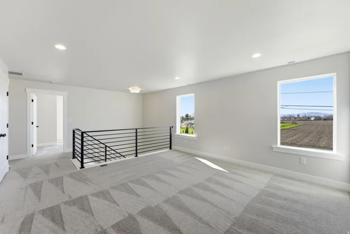Spare room with light colored carpet and recessed lighting