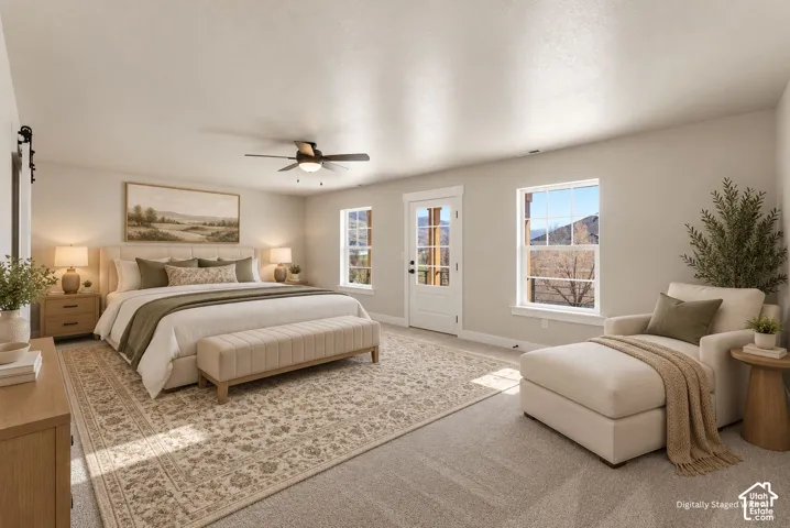 Light-colored carpeting, multiple windows providing natural light, a ceiling fan fixture, and a French door with glass panels