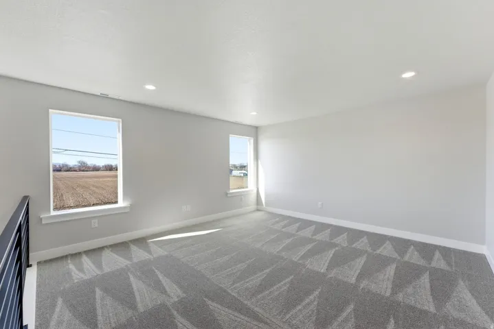 Empty room featuring light carpet and recessed lighting