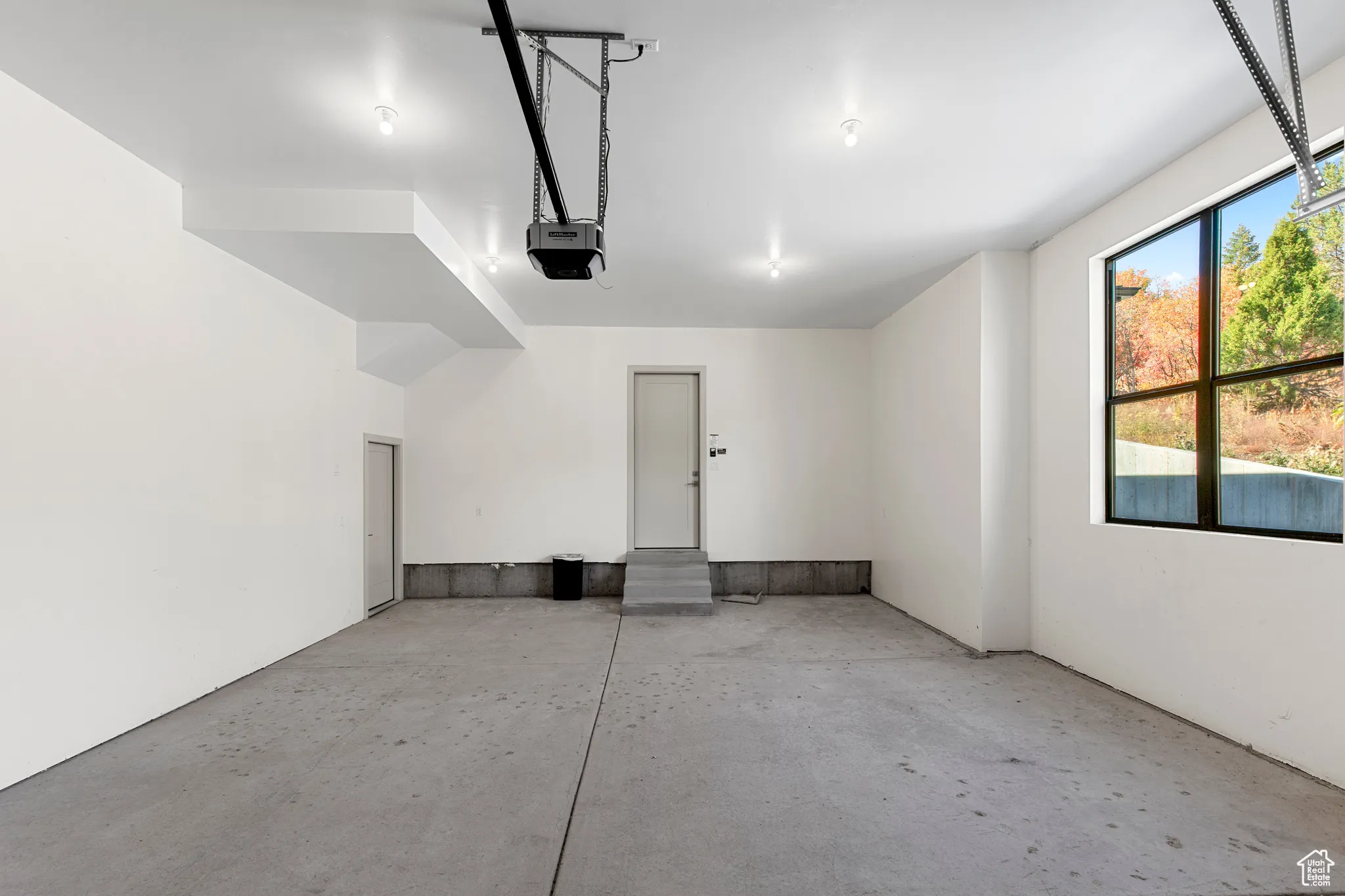 Garage featuring a garage door opener