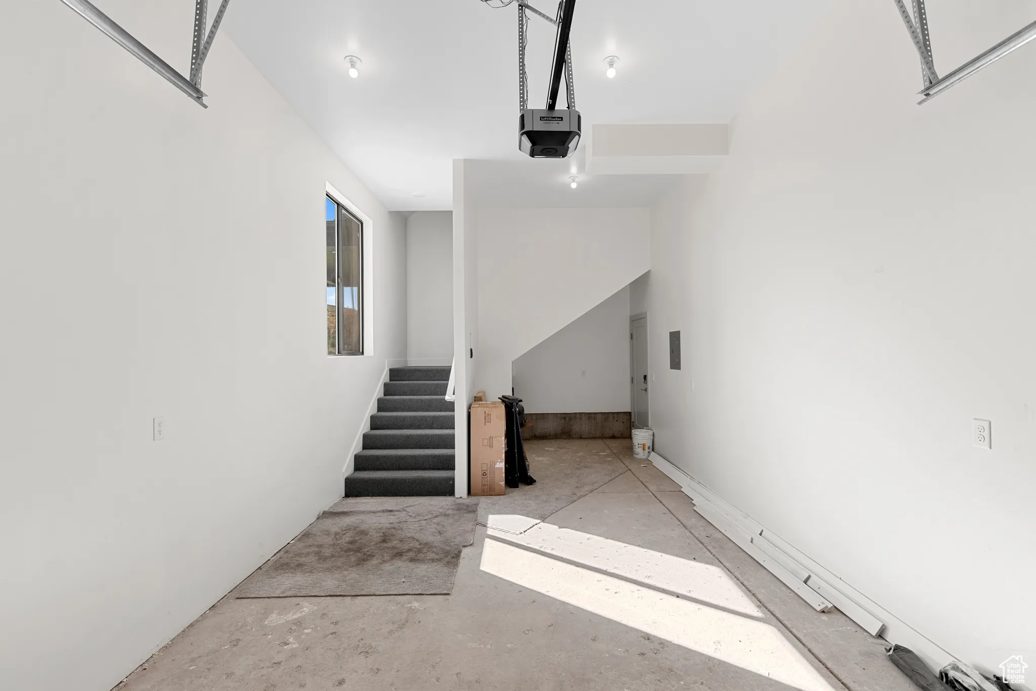 Stairs featuring unfinished concrete flooring