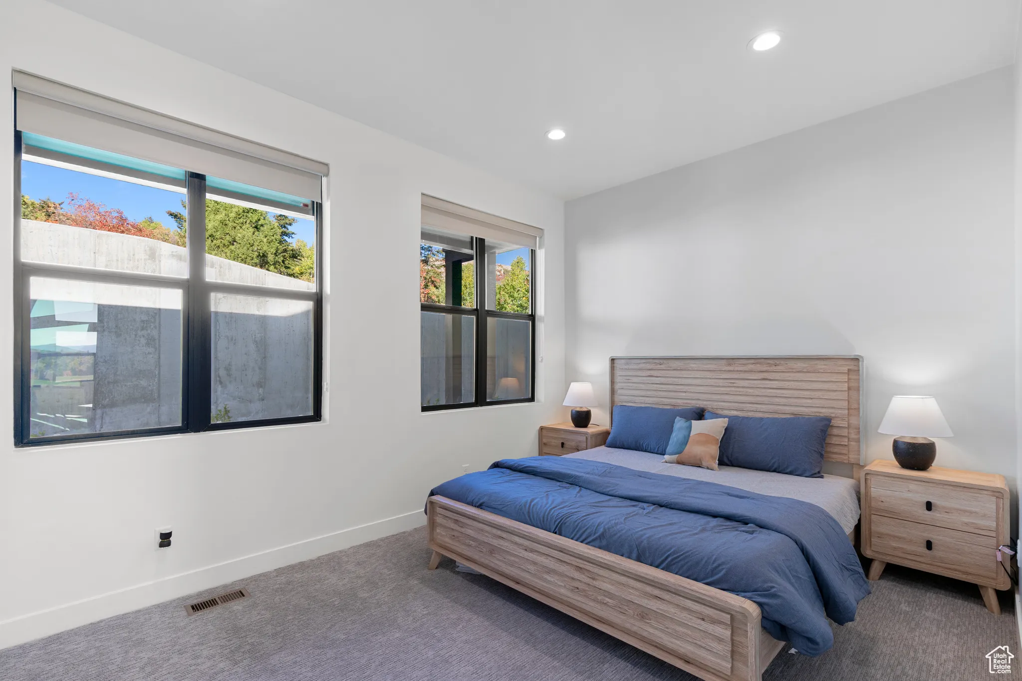 Carpeted bedroom with baseboards and recessed lighting