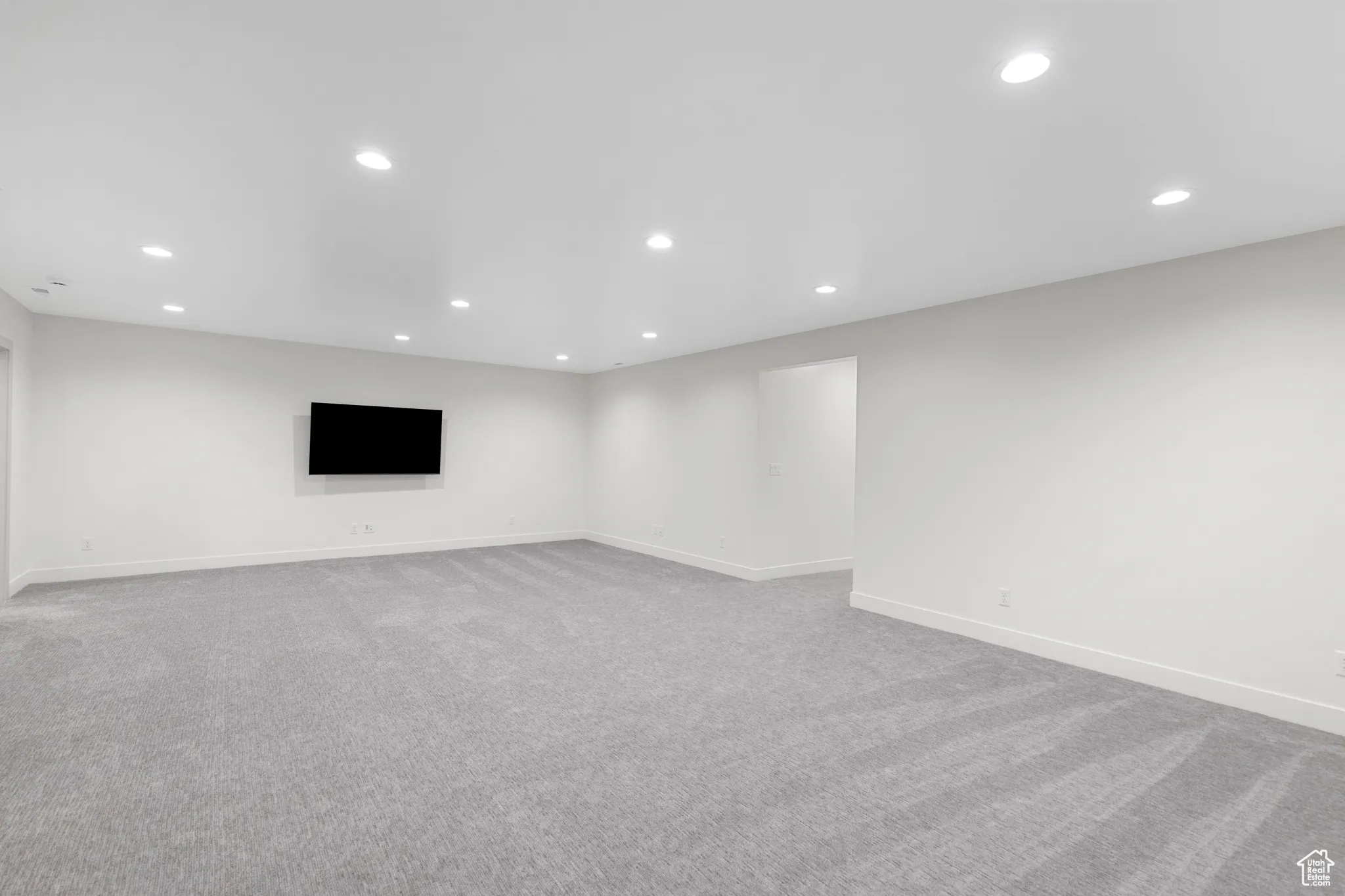Basement featuring light colored carpet and recessed lighting
