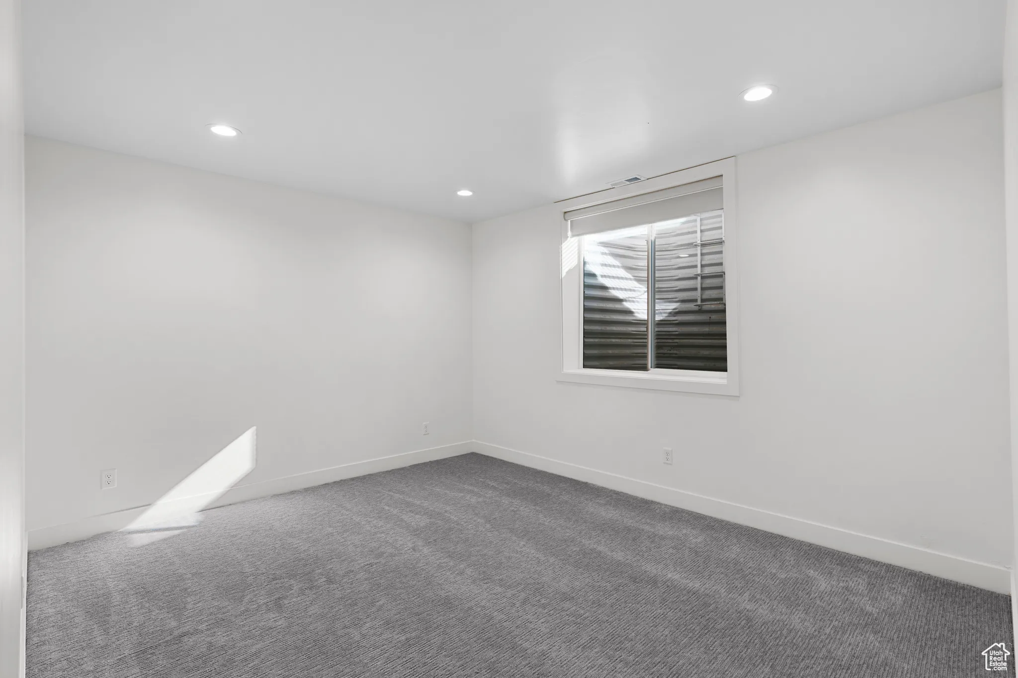 Spare room featuring carpet flooring and recessed lighting