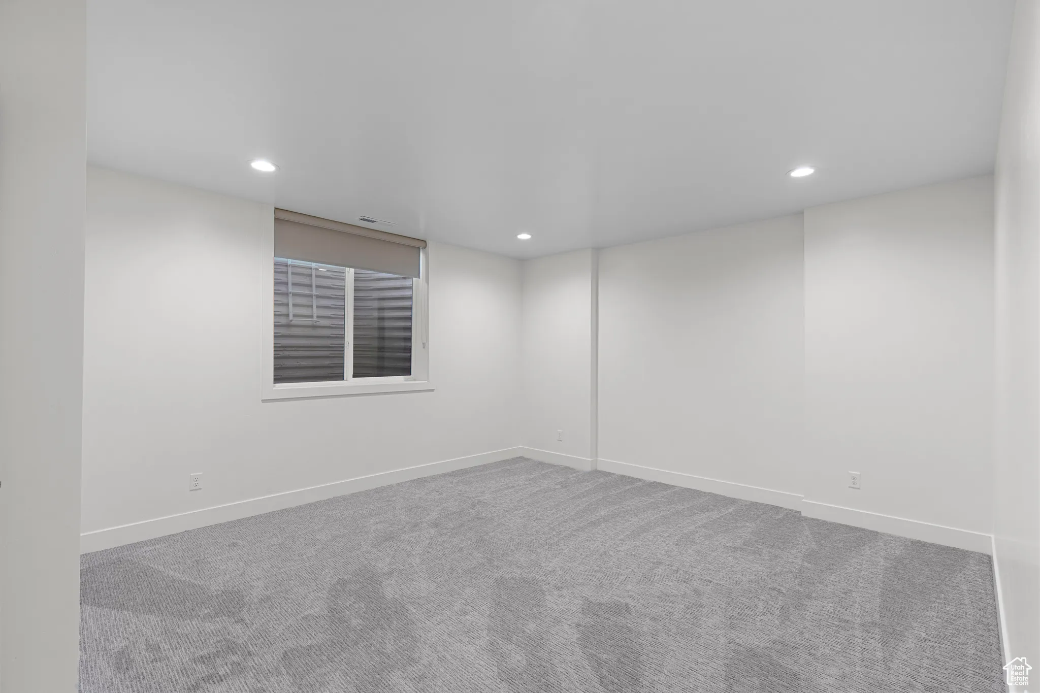 Empty room featuring carpet and recessed lighting