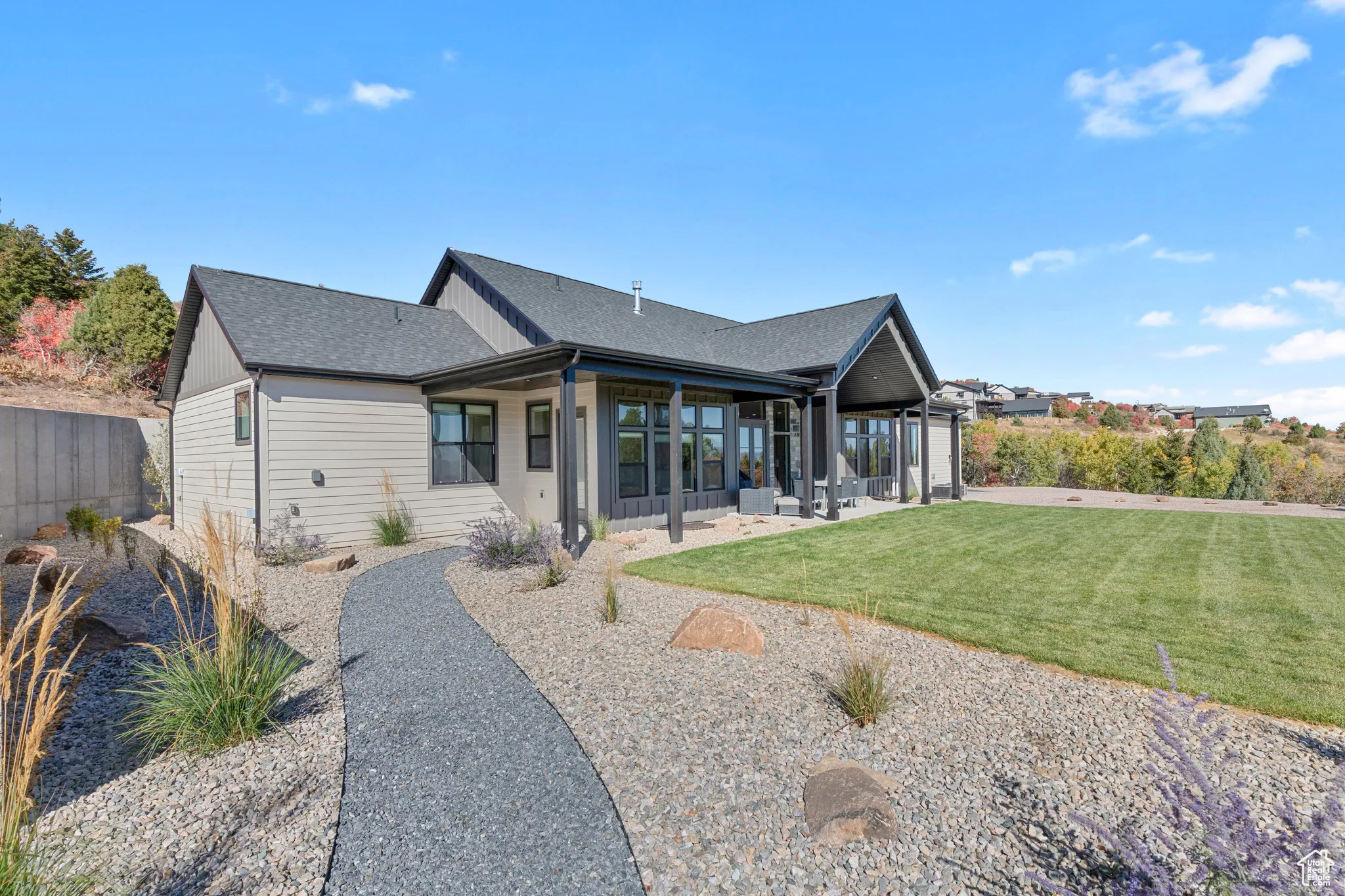 Rear view of property with a patio and roof with shingles