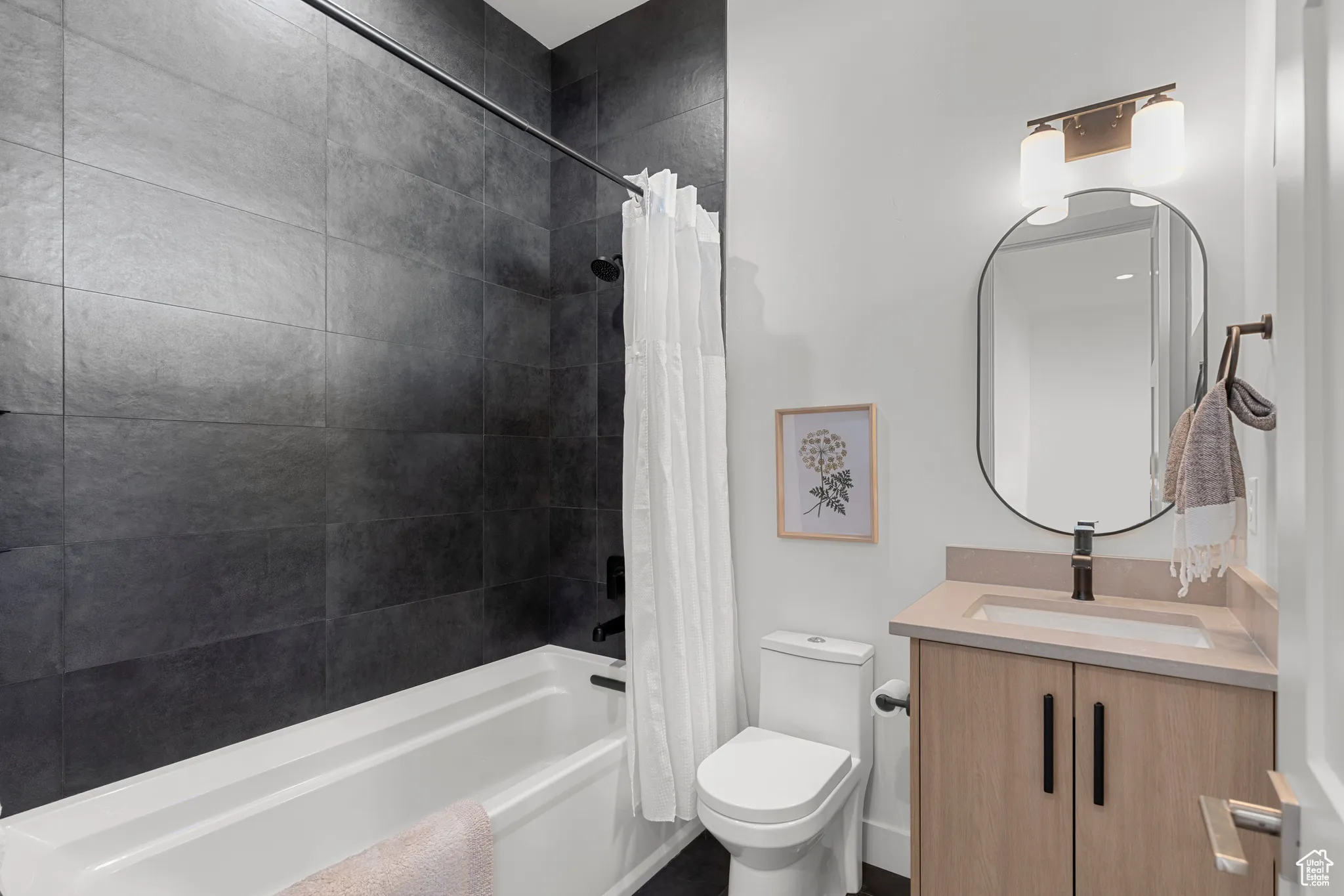 Full bath featuring shower / bath combo and vanity