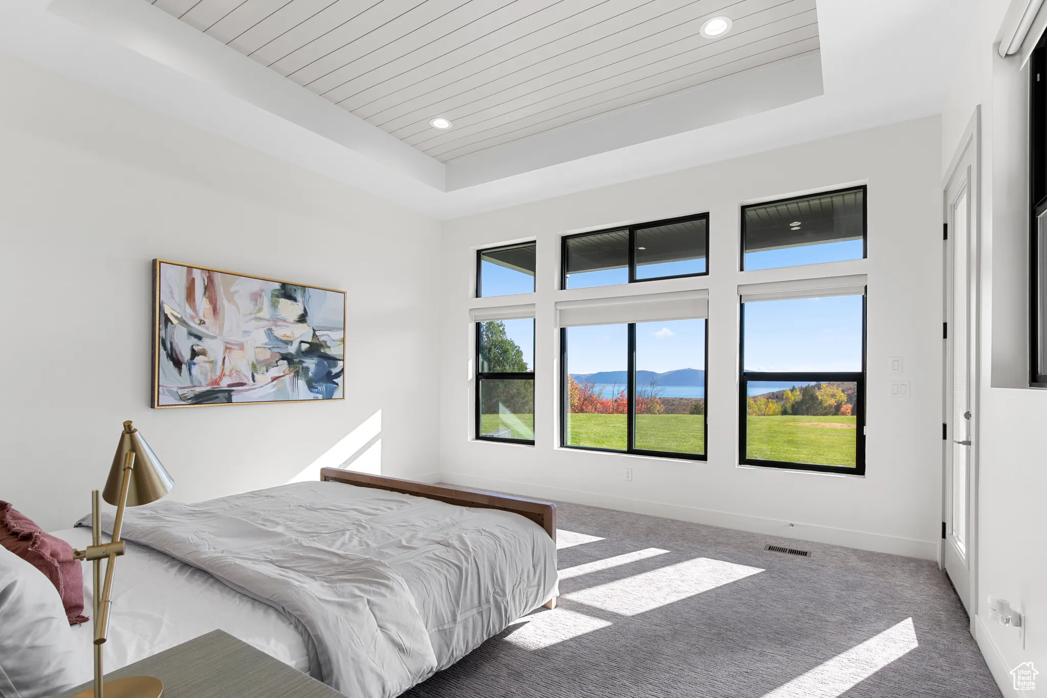 Carpeted bedroom with a tray ceiling, a mountain view, wood ceiling, and recessed lighting