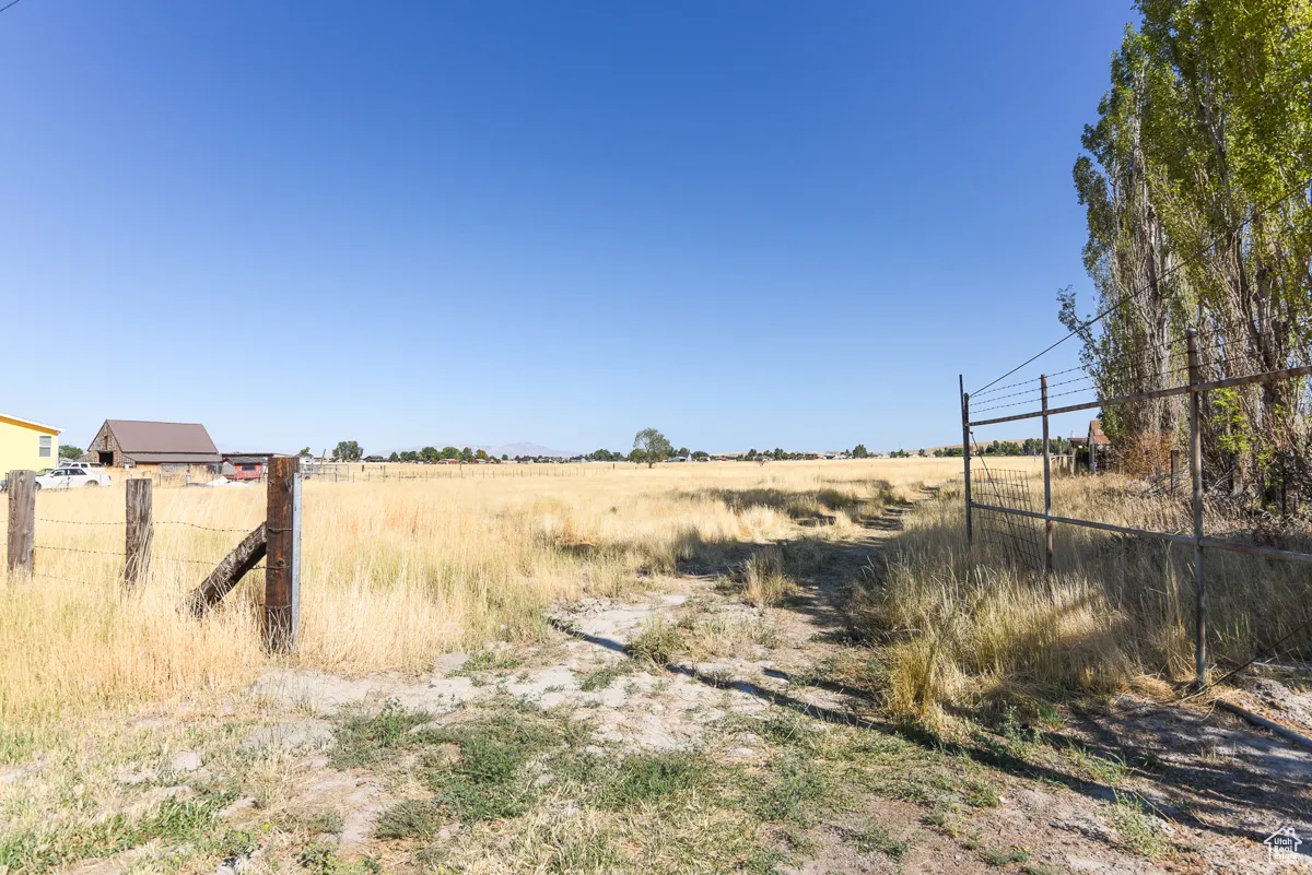 View of yard with a rural view
