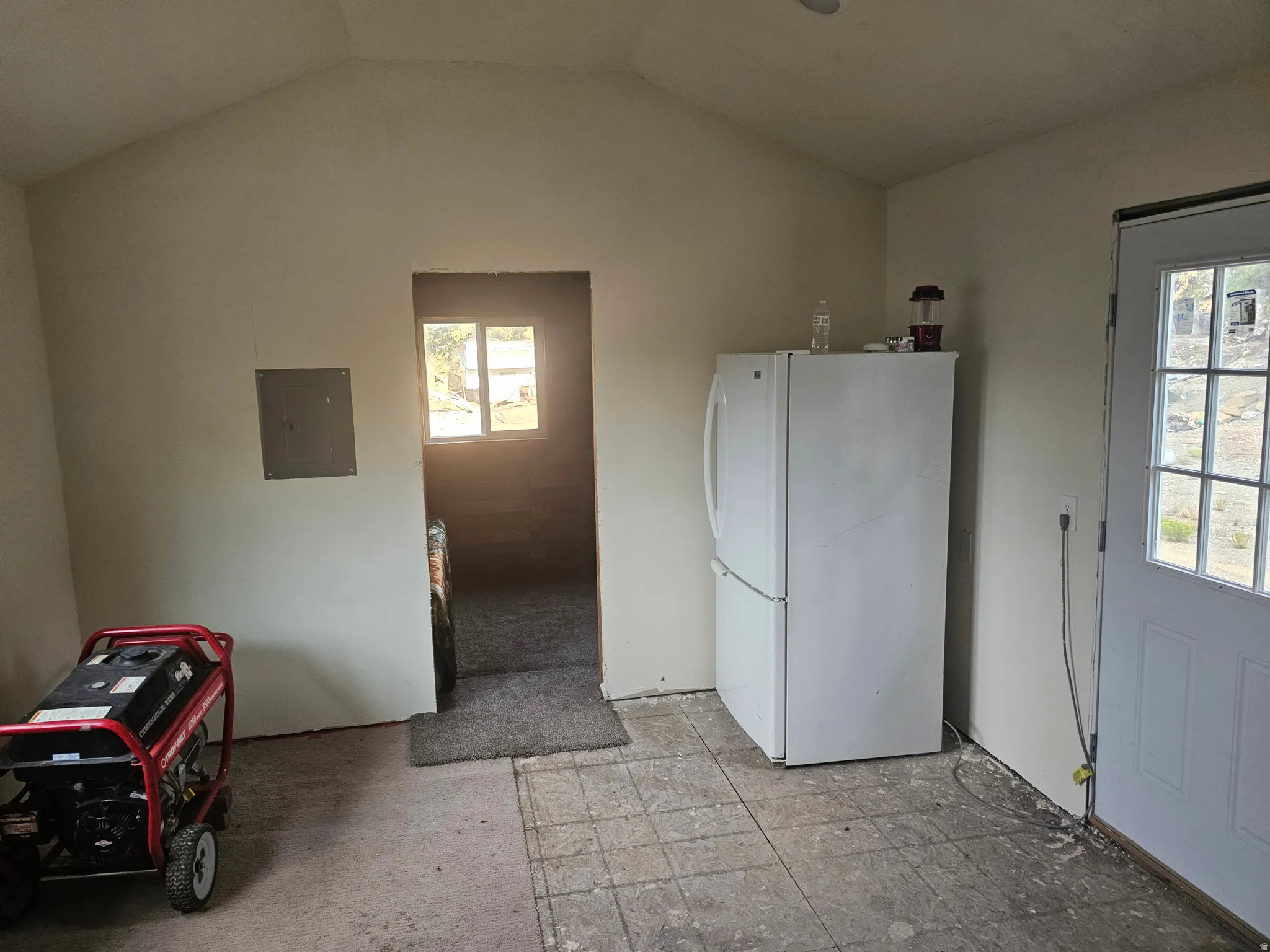 Washroom featuring electric panel and lofted ceiling