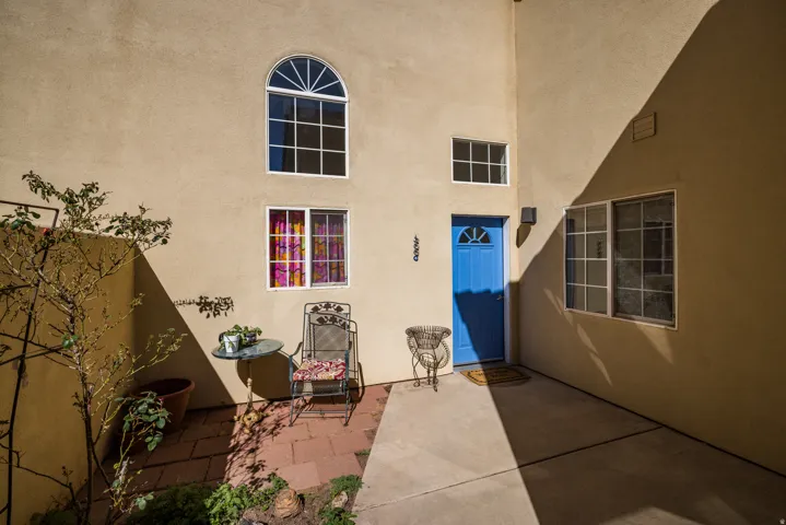 Entrance to property featuring a patio and stucco siding