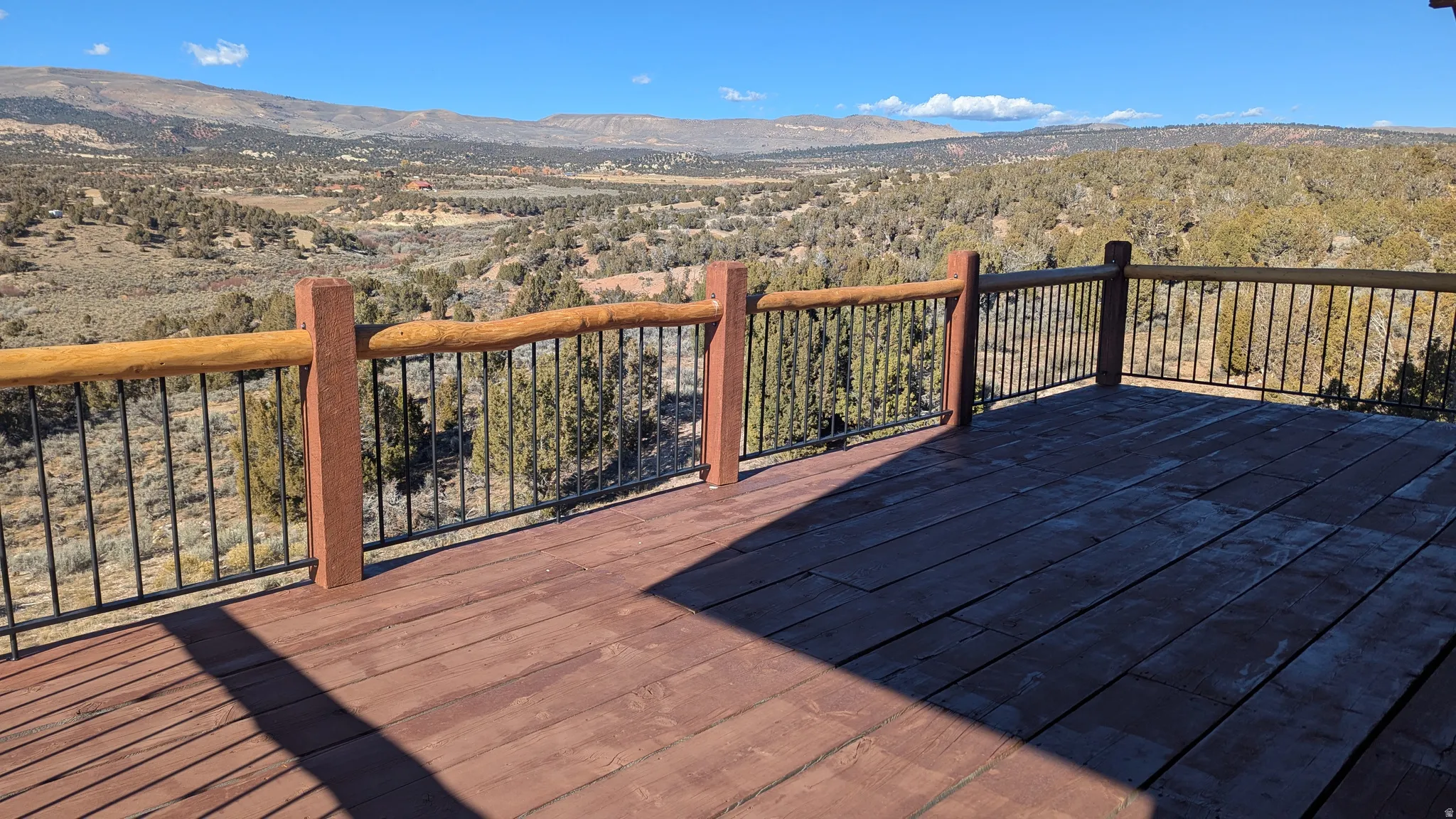 Wooden deck featuring a mountain view and a forest view