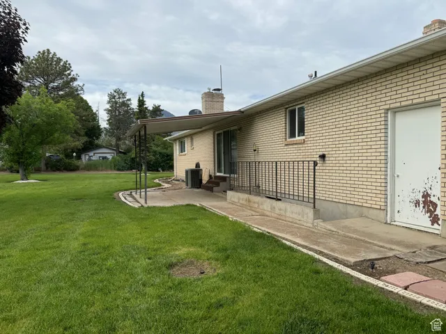 Back of home with basement entrance