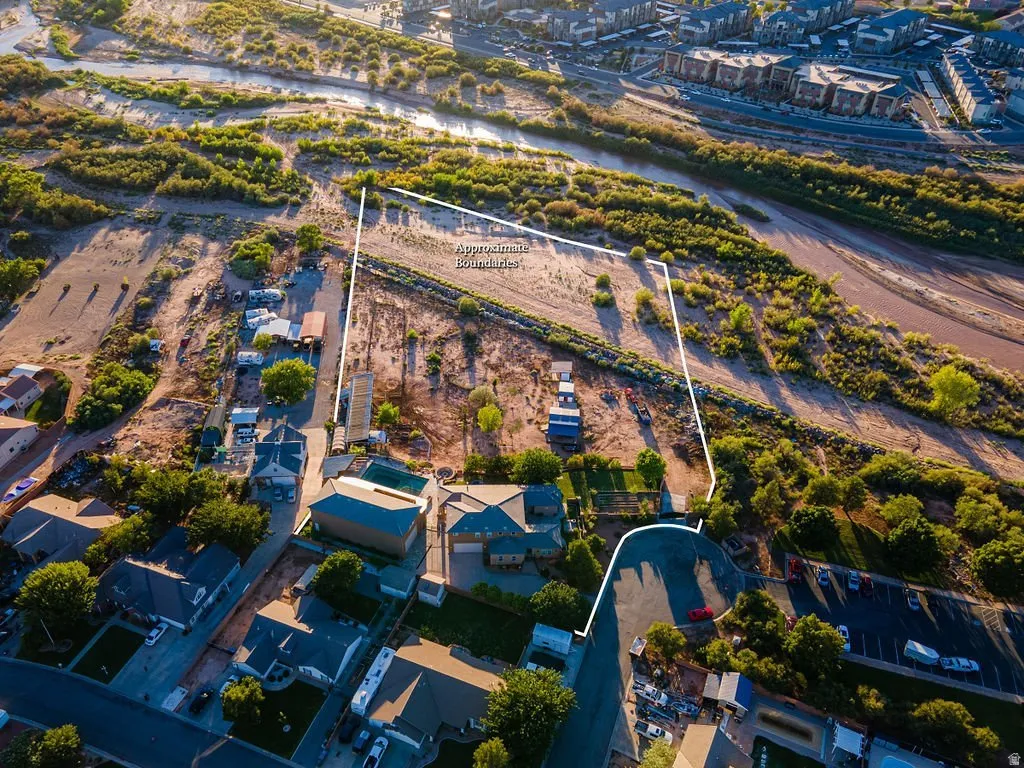 The full 3.43 acres from above with approximate lot lines: home, pool, RV garage, barns, corrals, and pasture — the river corridor running just beyond the back fence.