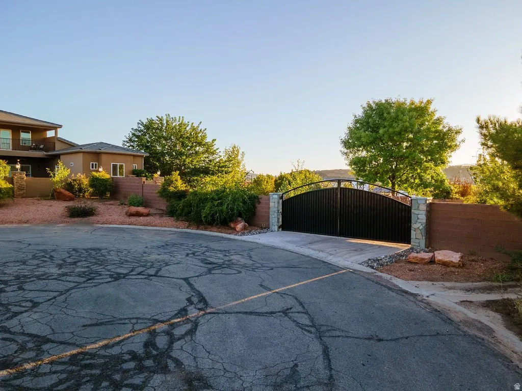 Iron gate and stone columns at the head of the private drive.
