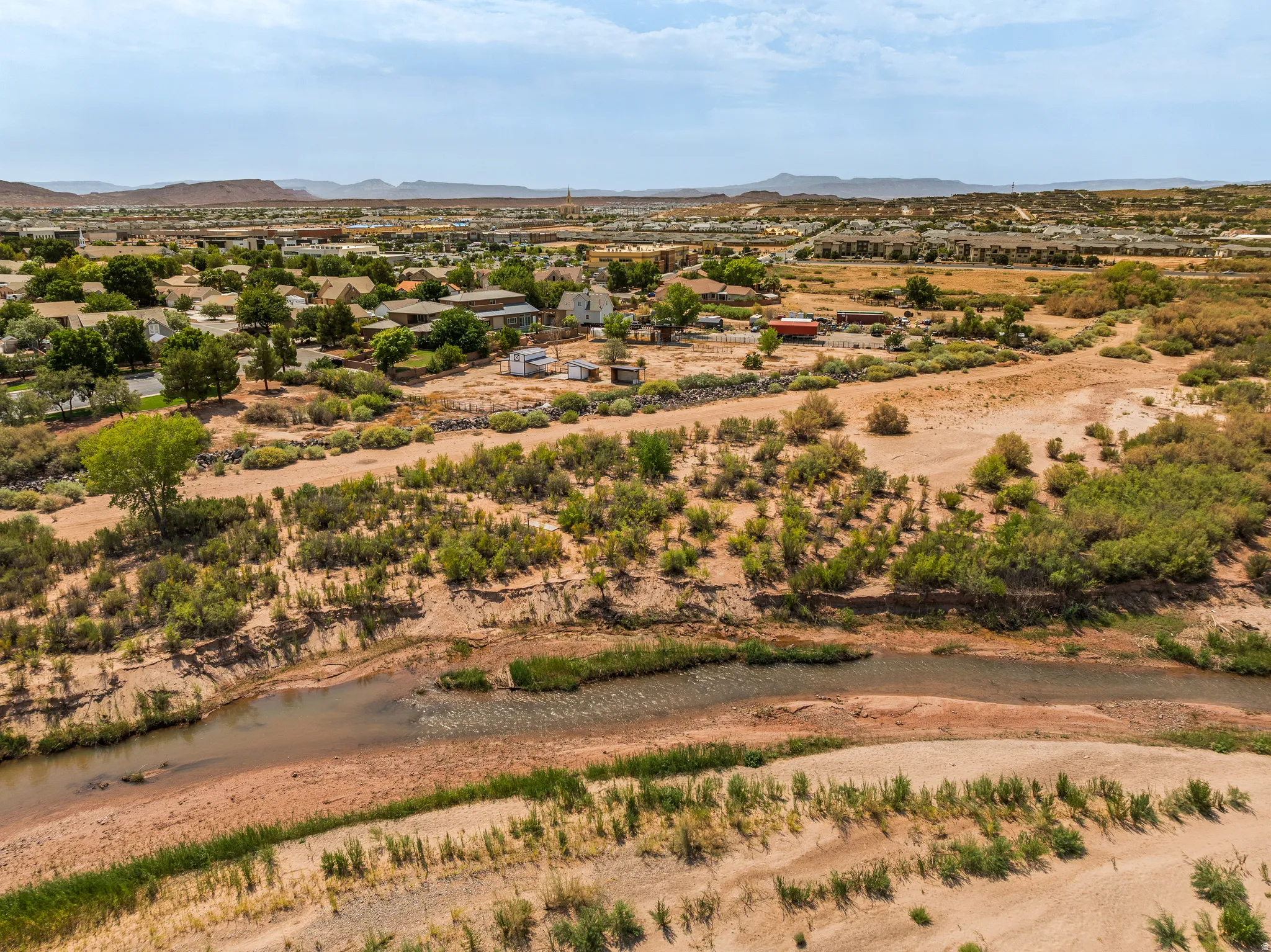 The river just past the property line, running through protected corridor land.