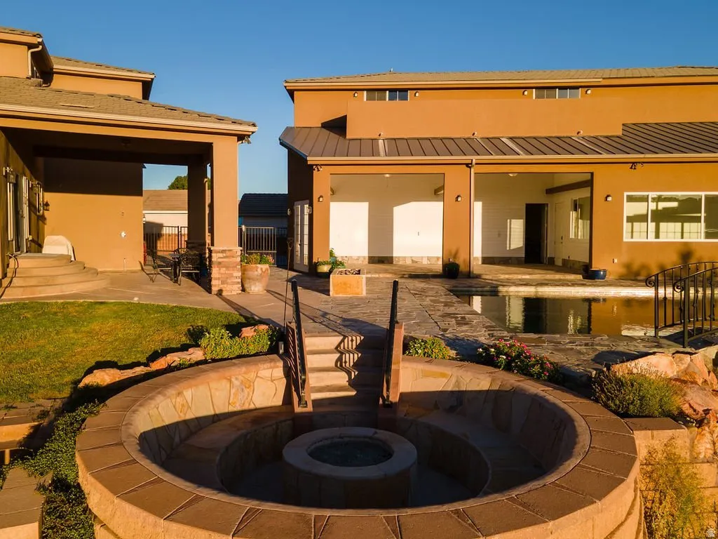 Fire feature set against the home at golden hour.