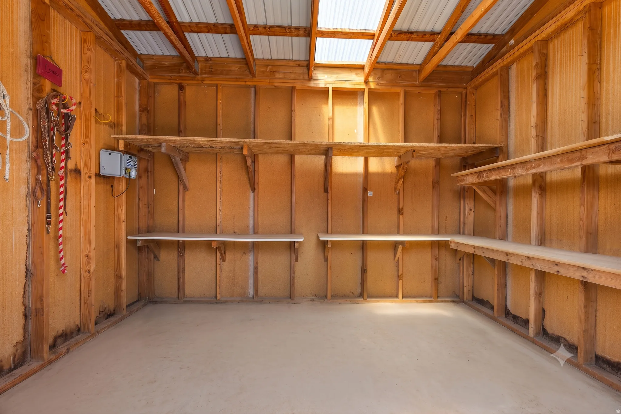 Skylit and insulated, with full-length shelving on three walls and tack hooks already mounted. Hang a saddle and you're moved in.