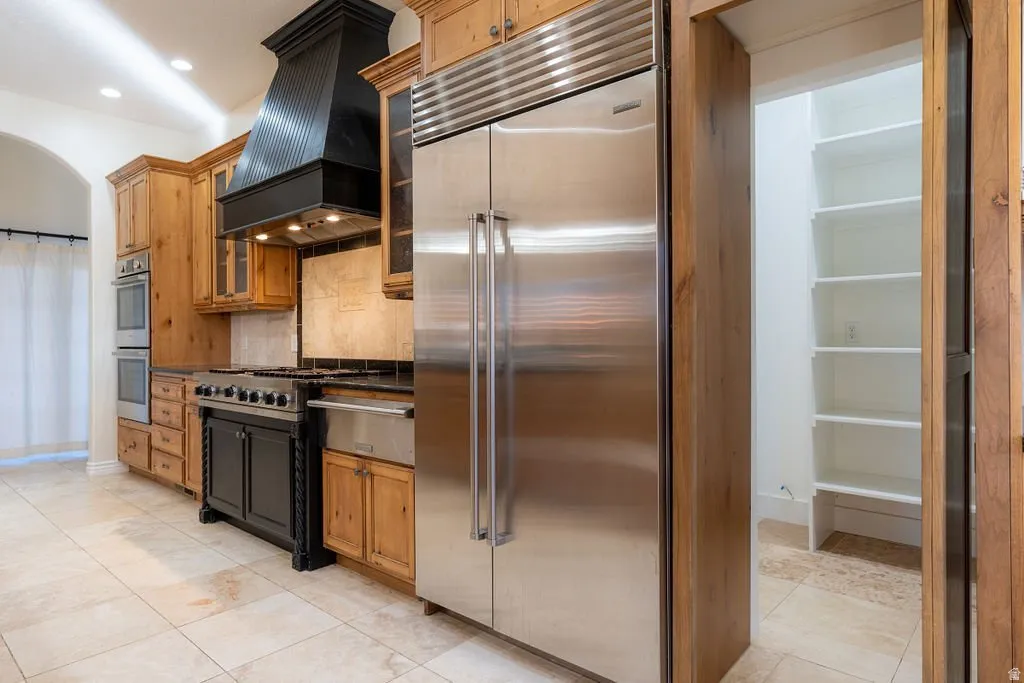 The cabinetry panel swings open to reveal the pantry behind it.