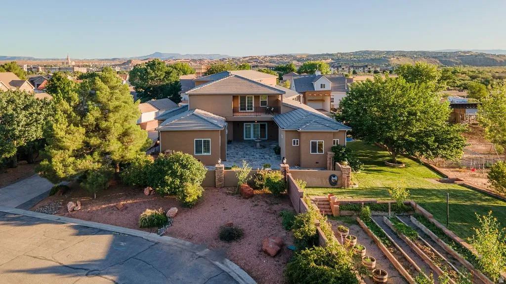 Home, gardens, and orchards from the air at golden hour.