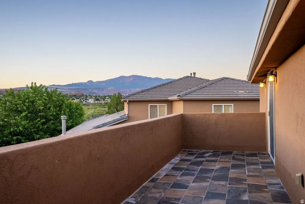 Private balcony off the studio level, looking out to the ridgeline.
