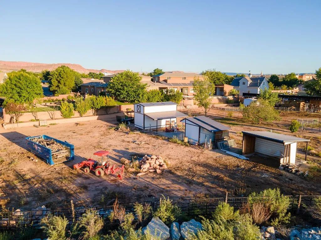 Zoned for up to eight horses with the infrastructure standing — level ground, pipe fencing, covered shelter, room to work.