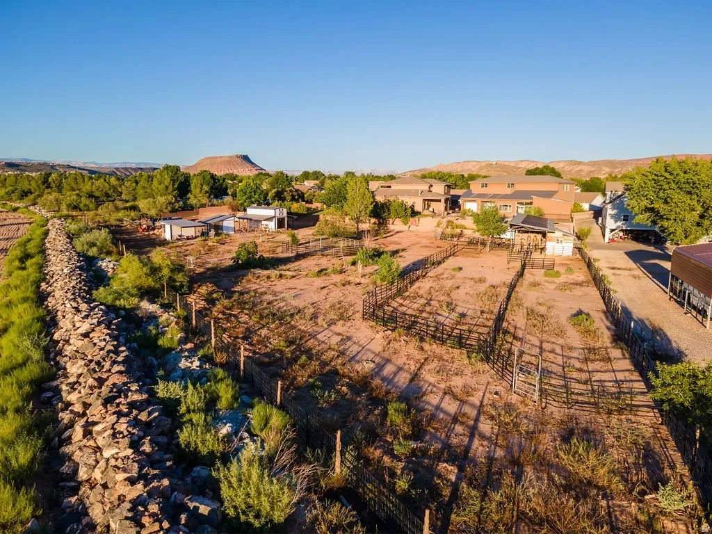Elevated siting — two feet above neighboring properties, with the valley opening beyond.