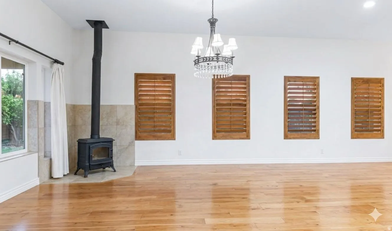 Vaulted dining with a wood-burning stove and plantation shutters.