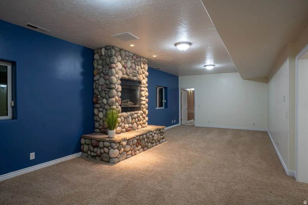 Second family room with stacked stone fireplace.
