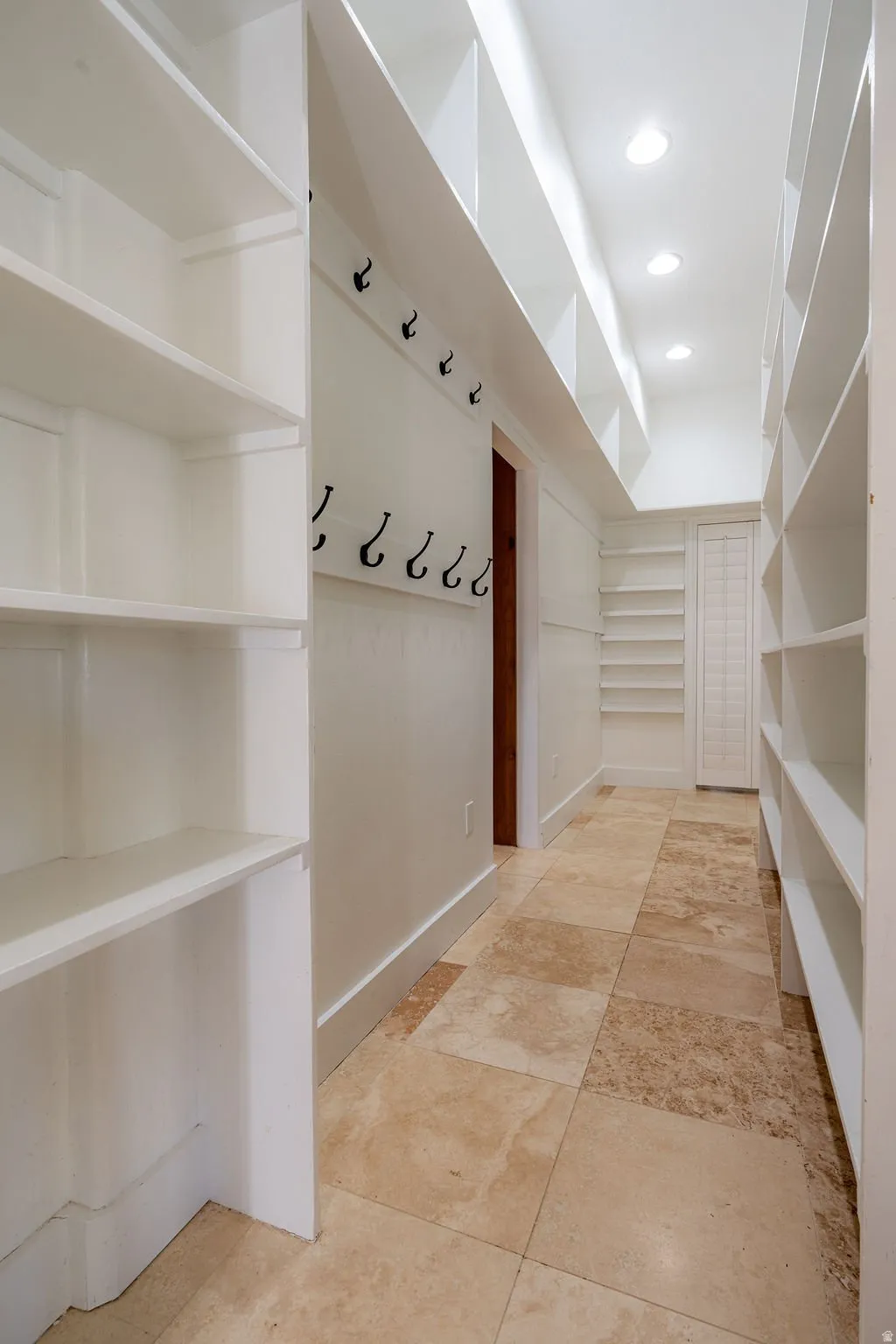 Custom shelving down both walls. Real storage, not a closet.