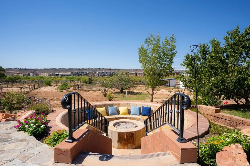 A sunken fire pit with built-in seating, dropped below grade for wind shelter and wide sky.
