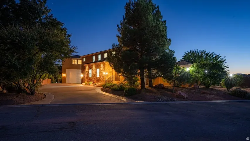 Arrive at the end of a quiet cul-de-sac, down a long private drive, to a home lit against the desert dusk — 3.43 acres of your own at the edge of the Virgin River corridor.