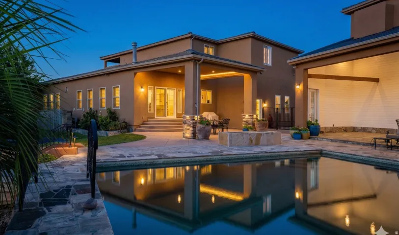 Back of property with a patio, stucco siding, an outdoor pool, and entry steps