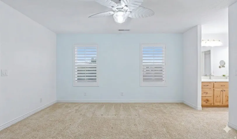Oversized upstairs bedroom with attached vanity area.