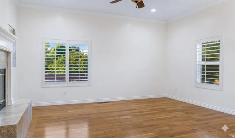 A quieter second sitting room off the entry, with its own fireplace.