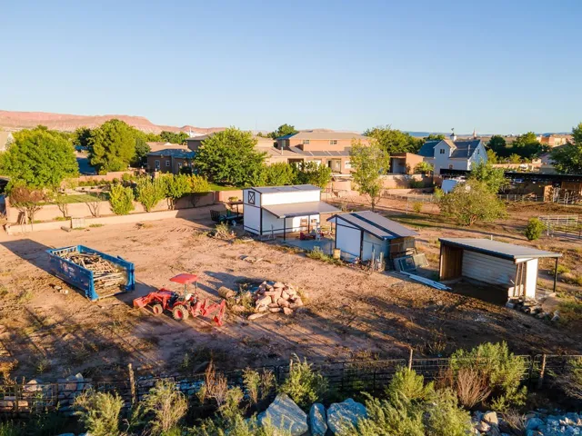 Zoned for up to eight horses with the infrastructure standing — level ground, pipe fencing, covered shelter, room to work.