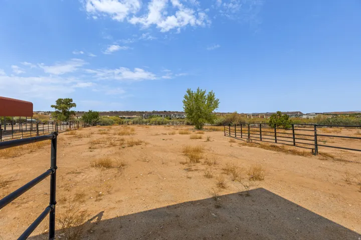 Pipe rail perimeter, level footing, and a mature shade tree. Usable turnout, not just acreage on paper.