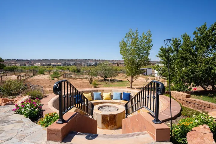 A sunken fire pit with built-in seating, dropped below grade for wind shelter and wide sky.